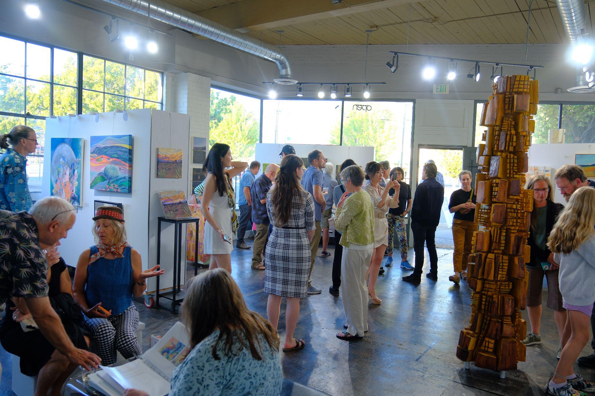 Community members gathered inside a Gallery B612 exhibition and event space.